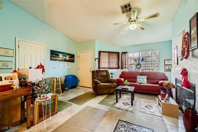 living room with a textured ceiling, ceiling fan, and lofted ceiling