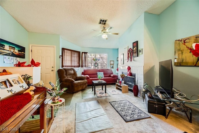 carpeted living room with ceiling fan and a textured ceiling