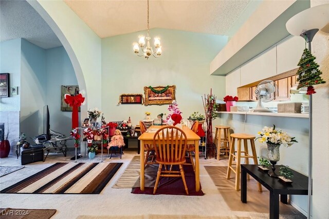 carpeted dining area featuring a chandelier and lofted ceiling