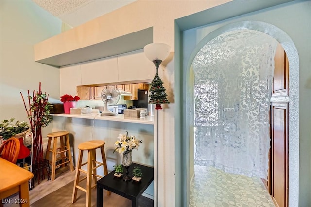 kitchen featuring white cabinets and kitchen peninsula