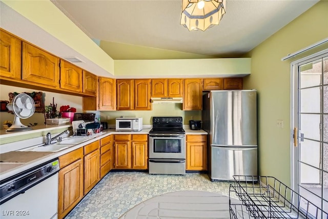 kitchen featuring sink, lofted ceiling, and stainless steel appliances