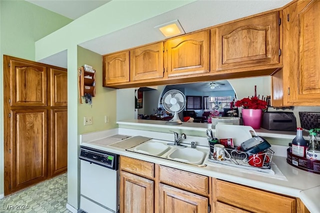 kitchen with white dishwasher, ceiling fan, and sink