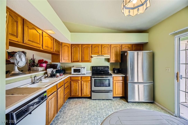 kitchen with stainless steel appliances, lofted ceiling, and sink