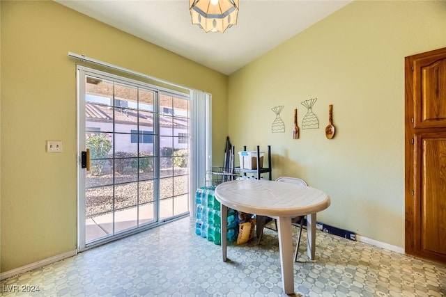 dining room featuring lofted ceiling