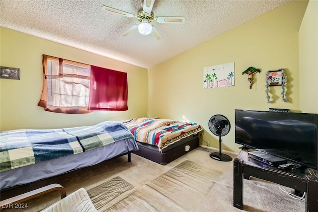 bedroom featuring a textured ceiling, ceiling fan, light colored carpet, and lofted ceiling