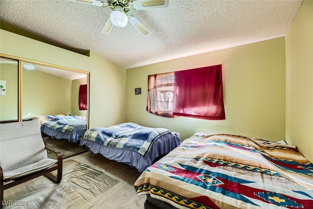 bedroom featuring carpet flooring, ceiling fan, lofted ceiling, and a textured ceiling