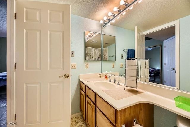 bathroom featuring vanity and a textured ceiling