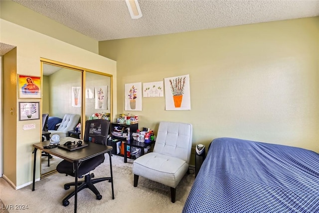 carpeted bedroom with a closet and a textured ceiling