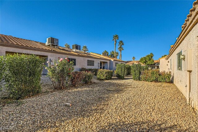 rear view of property featuring central AC unit