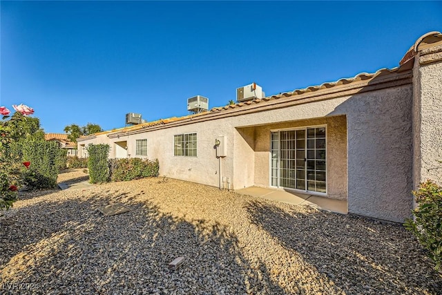 rear view of house with central AC