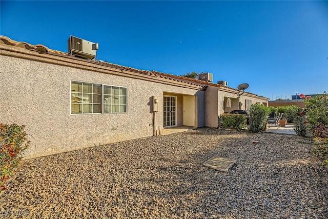 exterior space featuring cooling unit and a patio