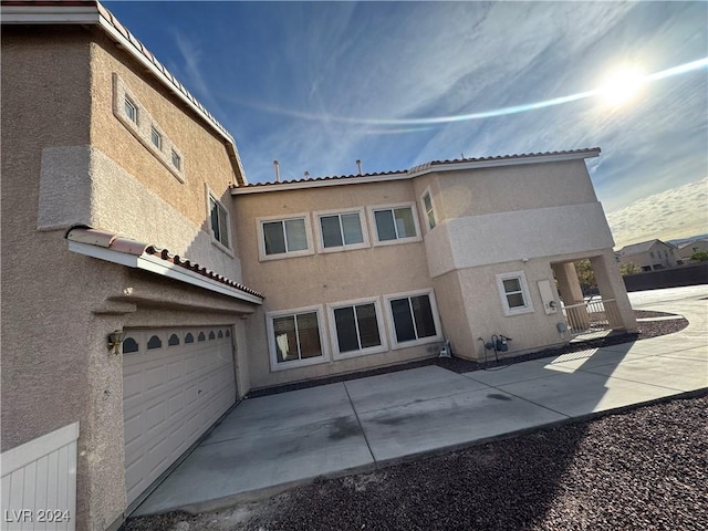 rear view of house with a garage