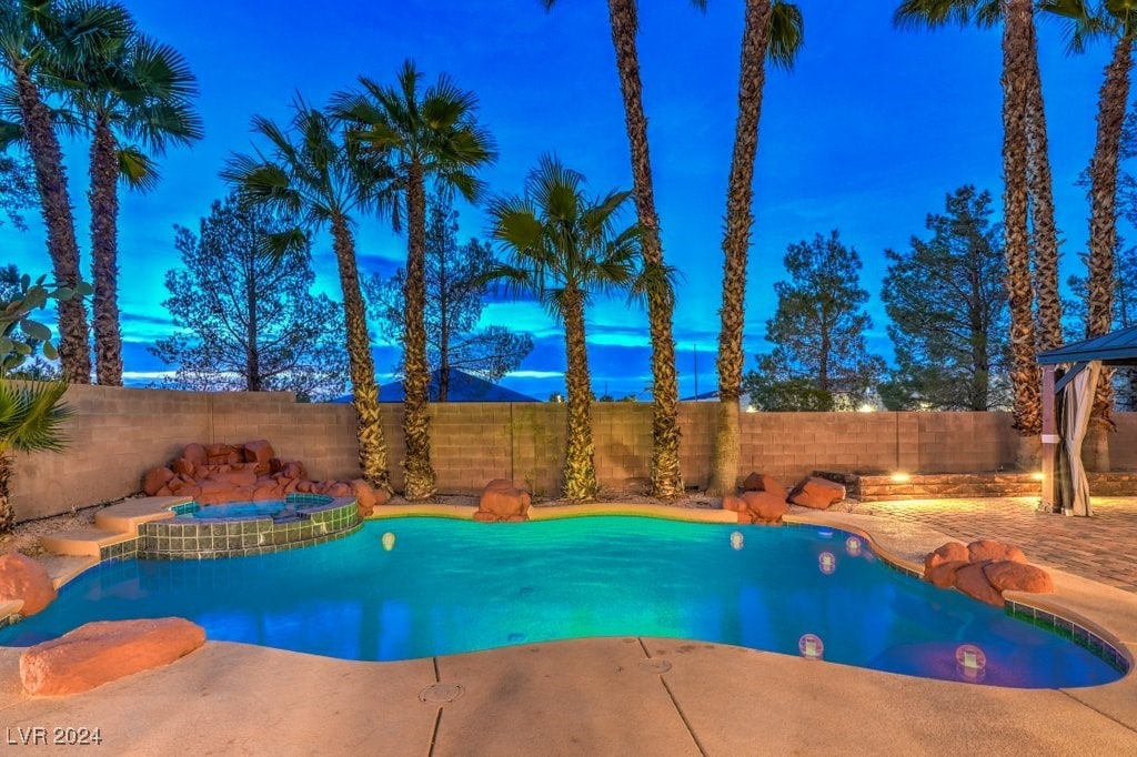 view of pool at dusk