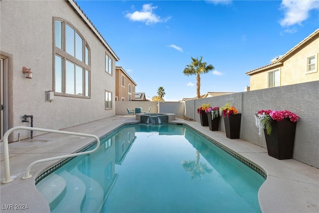 view of swimming pool featuring central air condition unit and an in ground hot tub