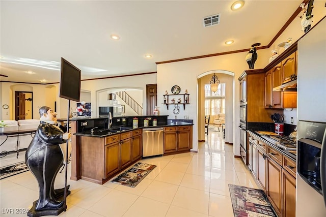373 Via Sonador, Henderson, NV 89012 - kitchen with dark stone counters, sink, light tile patterned floors, ornamental molding, and appliances with stainless steel finishes