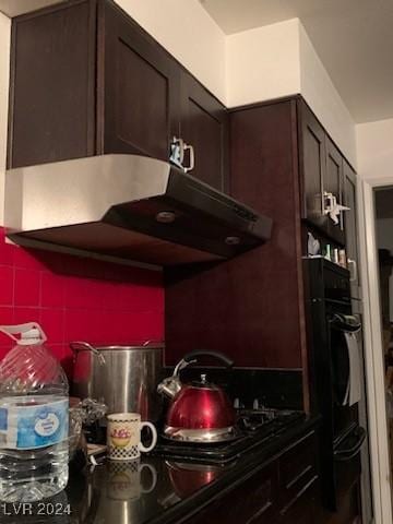 kitchen featuring dark brown cabinetry and black oven