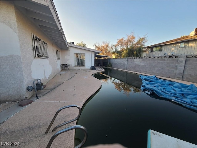 view of swimming pool with a patio area