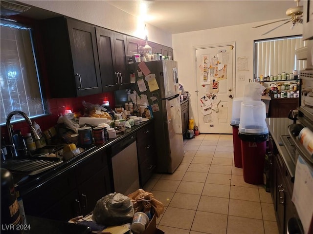 kitchen with sink, dark brown cabinets, light tile patterned floors, appliances with stainless steel finishes, and ceiling fan