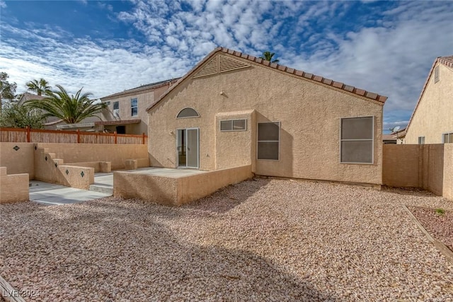 back of house with a patio area