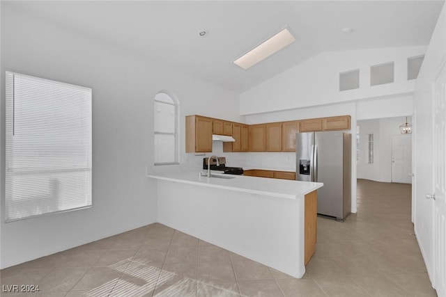 kitchen featuring sink, stainless steel appliances, high vaulted ceiling, kitchen peninsula, and light tile patterned floors