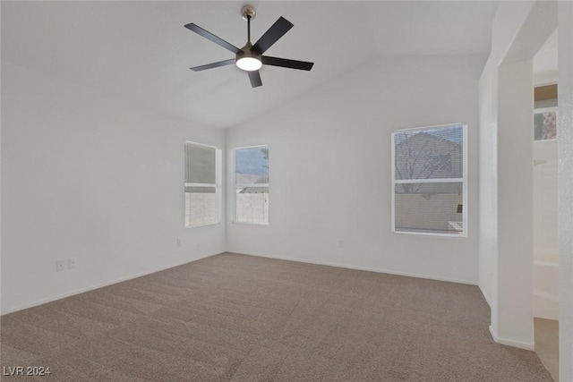 carpeted empty room featuring ceiling fan and lofted ceiling