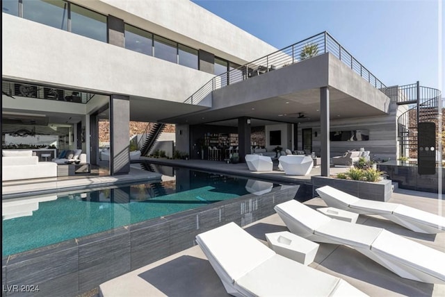 view of pool featuring an outdoor living space and a patio