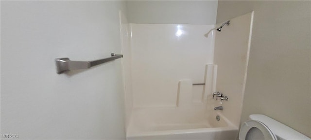 bathroom with shower / bathtub combination and toilet