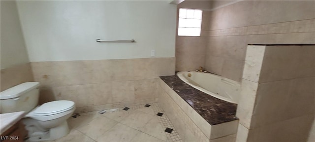 bathroom with vanity, toilet, tile walls, and a tub