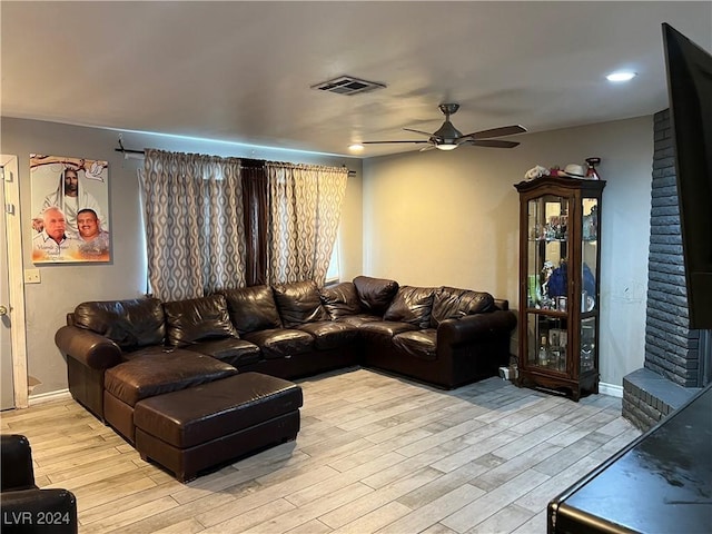 living room with ceiling fan and light wood-type flooring