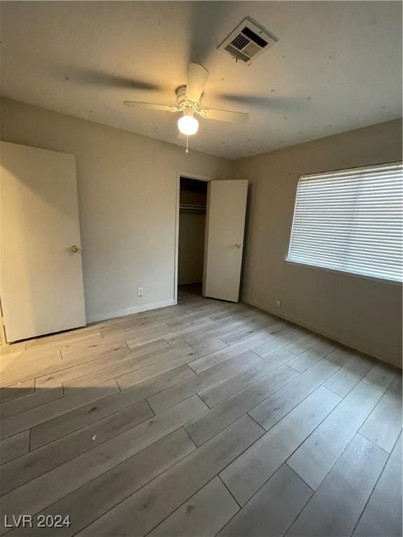 unfurnished room with ceiling fan and light hardwood / wood-style floors