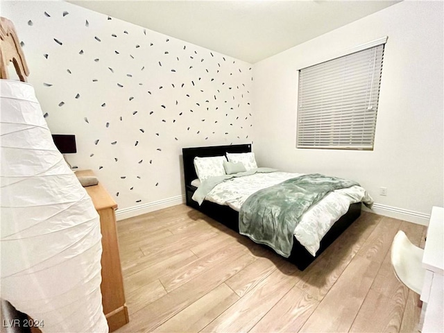 bedroom with hardwood / wood-style floors