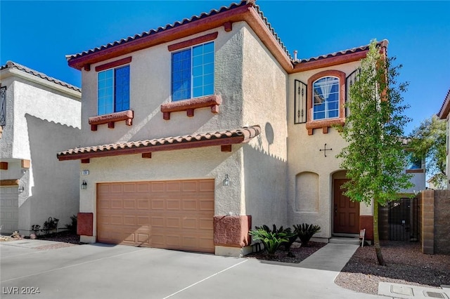 mediterranean / spanish-style home with a garage