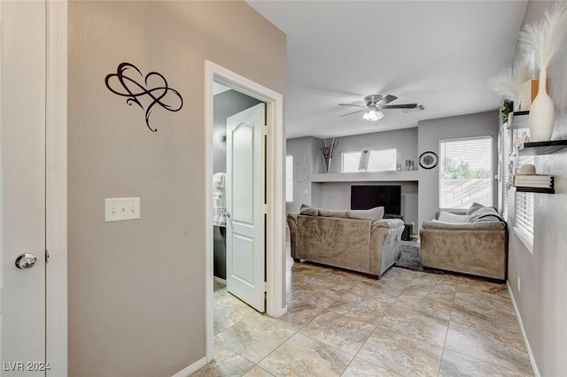 tiled living room featuring ceiling fan