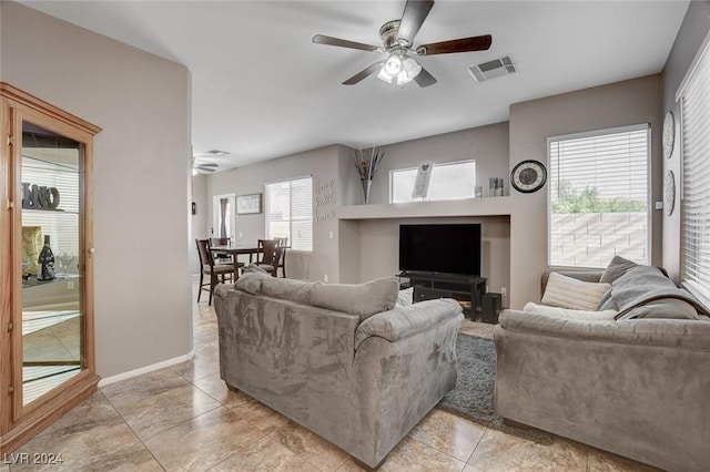 living room with light tile patterned floors and ceiling fan