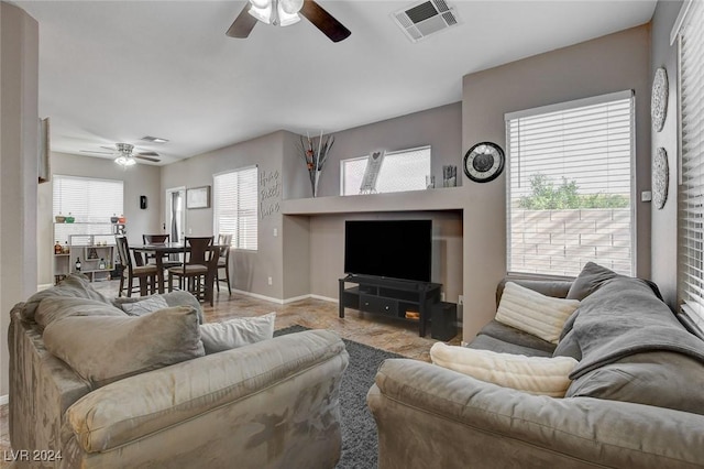 living room with ceiling fan and a healthy amount of sunlight