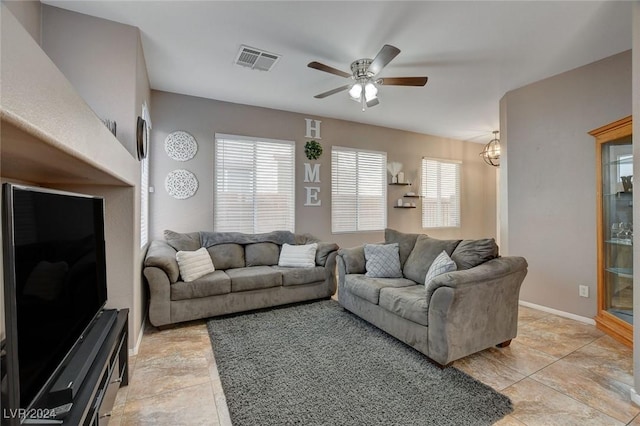 living room with ceiling fan with notable chandelier