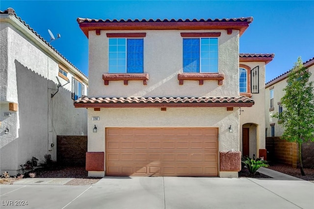 mediterranean / spanish-style home with a garage