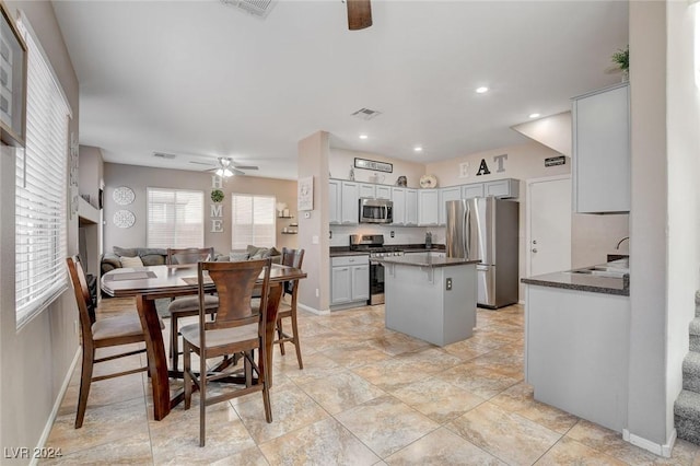 dining space with ceiling fan and sink