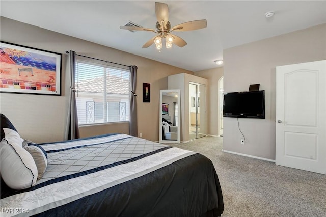 carpeted bedroom with ceiling fan and a closet