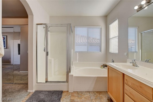 bathroom with vanity and separate shower and tub