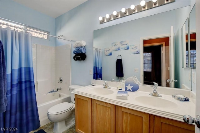 full bathroom with toilet, vanity, and shower / tub combo with curtain