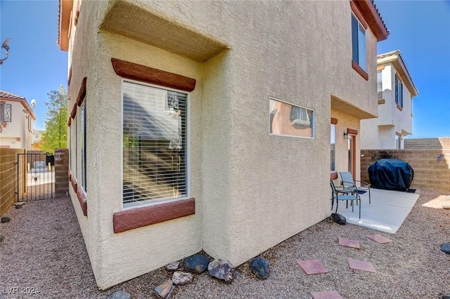 view of side of property with a patio