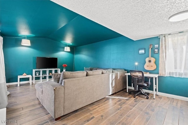 cinema room featuring vaulted ceiling and hardwood / wood-style flooring