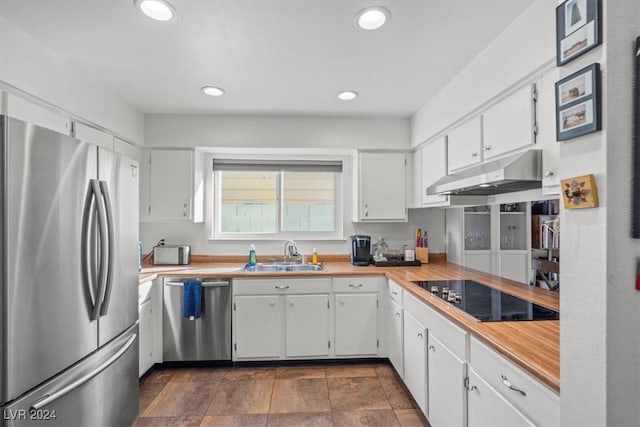 kitchen with white cabinetry, sink, and stainless steel appliances