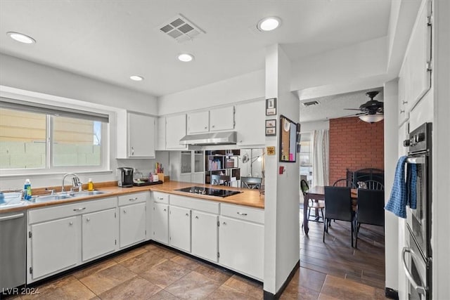 kitchen with appliances with stainless steel finishes, ceiling fan, sink, wood-type flooring, and white cabinetry