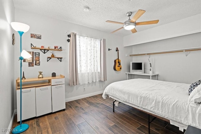 bedroom featuring ceiling fan, dark hardwood / wood-style flooring, and a textured ceiling