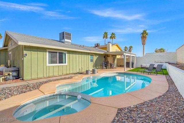 view of pool featuring central air condition unit, a patio area, and an in ground hot tub