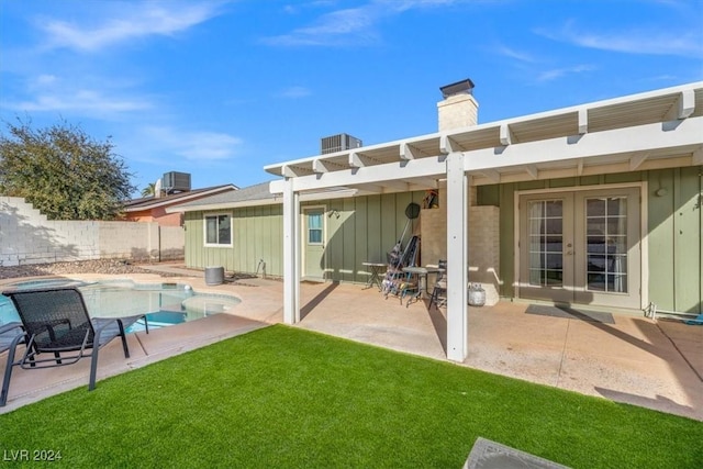 back of property with a lawn, a pergola, central air condition unit, a fenced in pool, and a patio area