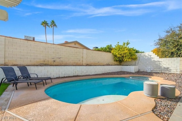 view of swimming pool featuring an in ground hot tub and central AC unit