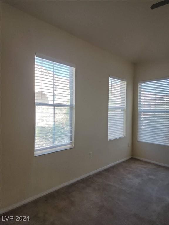 carpeted empty room with ceiling fan